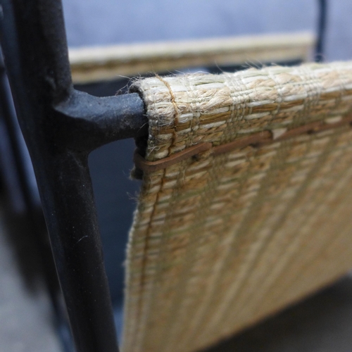 1473 - A rattan and iron magazine rack  * This lot is subject to VAT