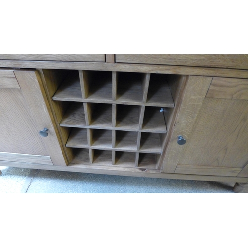 1534 - An oak two door wine sideboard * this lot is subject to VAT