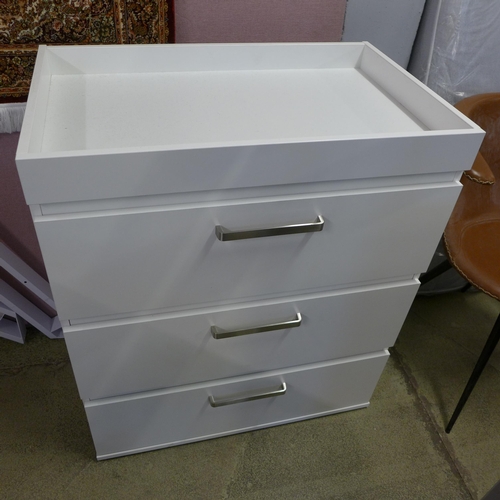 1645 - A white painted cot bed and a chest of three draws