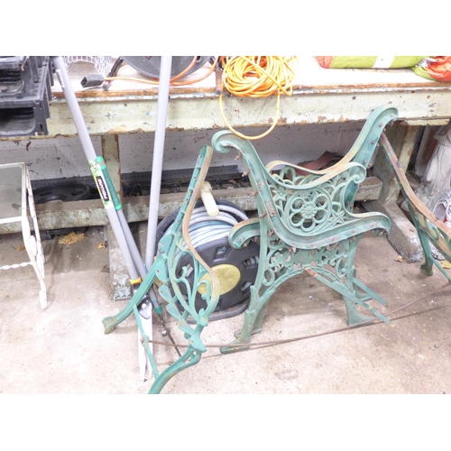 2433 - Steel wheelbarrow and two pairs of vintage floral cast iron bench ends