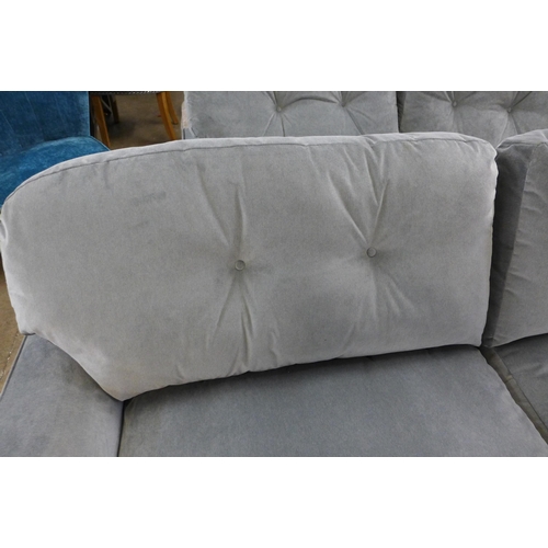 1301 - A grey velvet L shaped sofa on turned legs