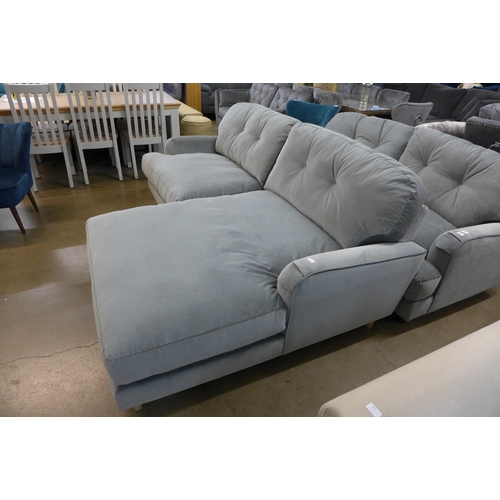 1301 - A grey velvet L shaped sofa on turned legs