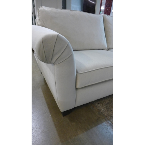 1400 - An ivory velvet three seater sofa