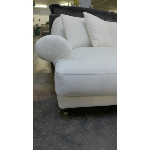 1431 - A white velvet three seater sofa