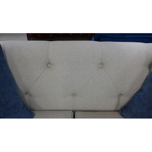 1441 - A light stone Chesterfield two seater sofa