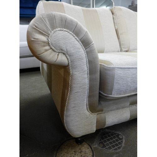 1491 - A beige and gold striped upholstered three seater sofa