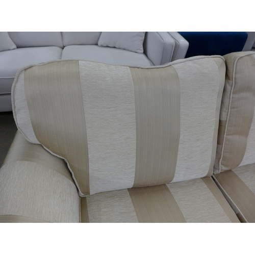 1491 - A beige and gold striped upholstered three seater sofa