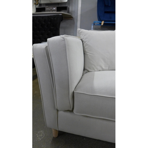 1519 - An ice white upholstered four seater sofa