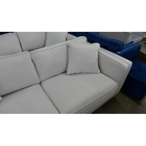 1519 - An ice white upholstered four seater sofa