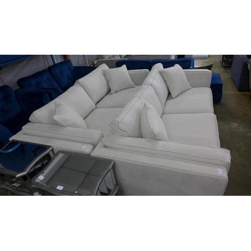 1519 - An ice white upholstered four seater sofa