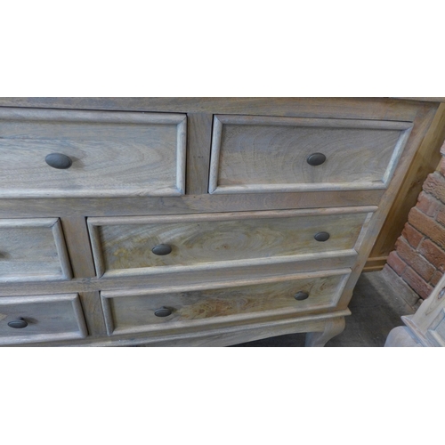 1541 - A French mango chest of seven drawers * this lot is subject to VAT