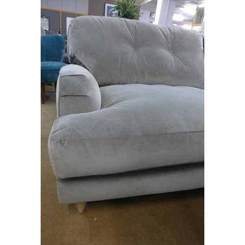 1301 - A grey velvet L shaped sofa on turned legs