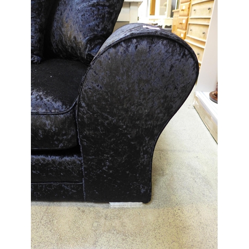 1603 - A black velvet three seater sofa