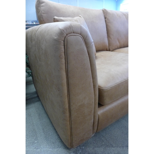 1619 - A tan upholstered four seater sofa