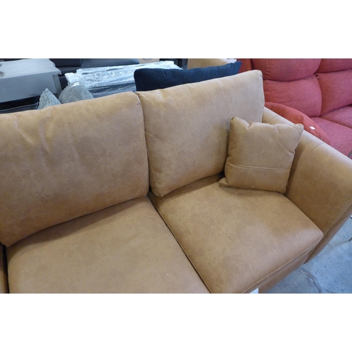 1619 - A tan upholstered four seater sofa