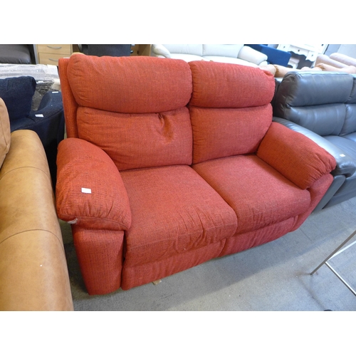 1621 - A red manual reclining two seater sofa - damaged