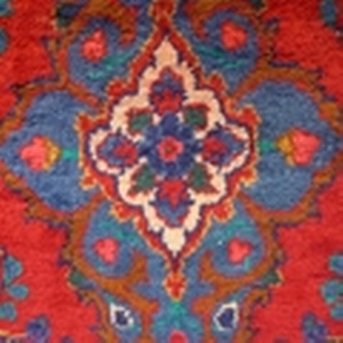 1557 - A rich red ground full pile large Persian runner, 330cm x 106cm