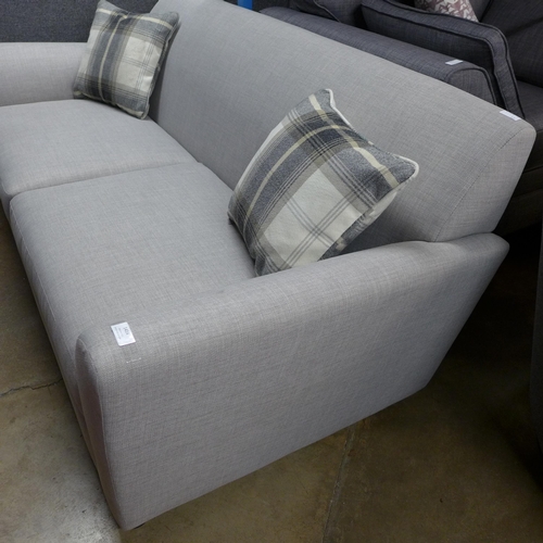 1414 - A grey stone three seater sofa