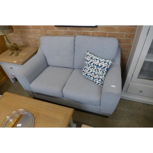 1530A - A pair of grey upholstered pinched back two seater sofas - marked