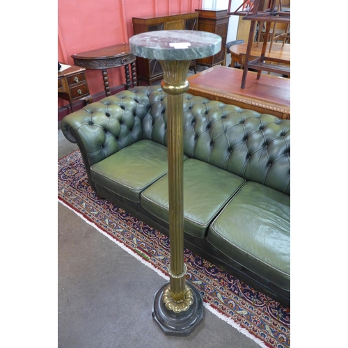 598 - An Italian style reeded brass and marble topped torchere