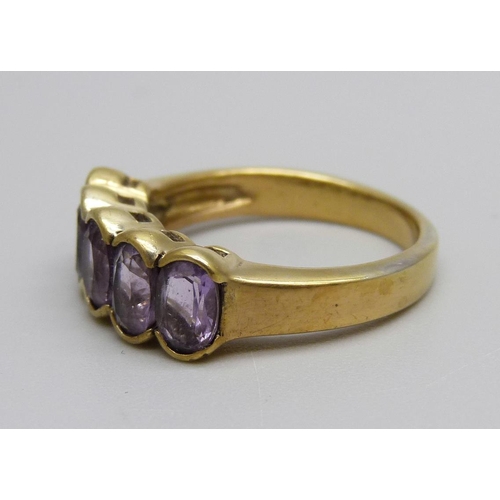 1005 - A silver gilt, five stone amethyst ring, O