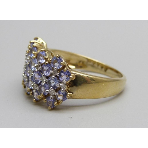 1020 - A 9ct gold, tanzanite (27) and diamond (16) ring, 3.9g, P