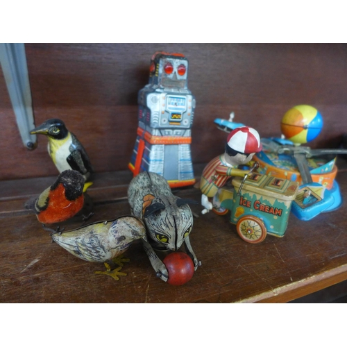 607 - A tin-plate clockwork robot, made in Japan, a tin-plate clockwork model penguin marked made in Gt. B... 