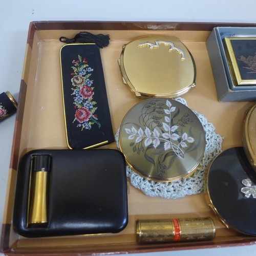 616 - A collection of vintage compacts, a needlepoint compact lipstick, Stratton comb, large clover musica... 