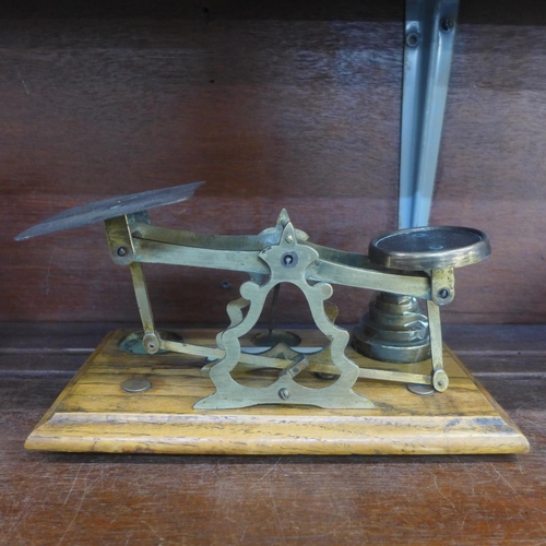 632 - A set of postal scales, with weights, ivorine plaque