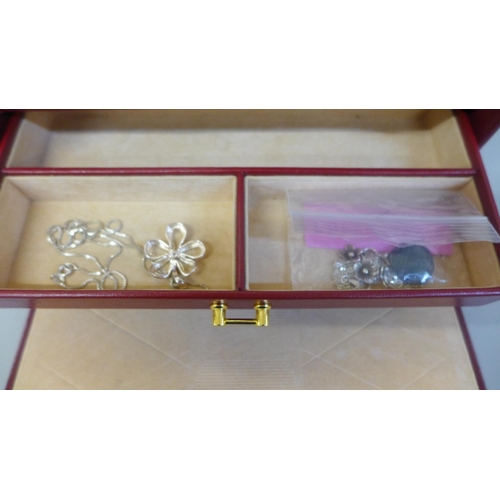 647 - A case of jewellery including some silver