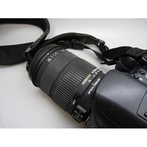 752 - A Canon D10 SLR digital camera with batteries, charger, etc., with Sigma 18:200mm lens