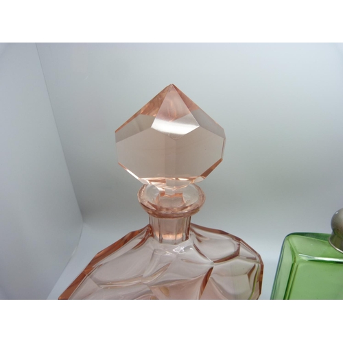 768 - A large Art Deco pink glass display bottle with original stopper, 23cm, and a green glass and a cran... 