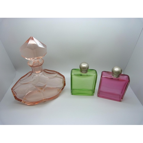 768 - A large Art Deco pink glass display bottle with original stopper, 23cm, and a green glass and a cran... 