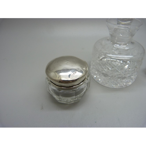 805 - A silver topped glass scent bottle with inner stopper, a silver topped glass jar, a cut glass bottle... 