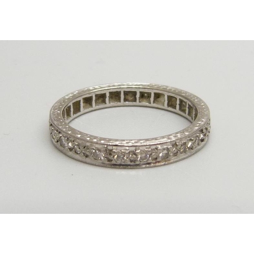 848 - A white metal and diamond eternity ring, 2.7g, O