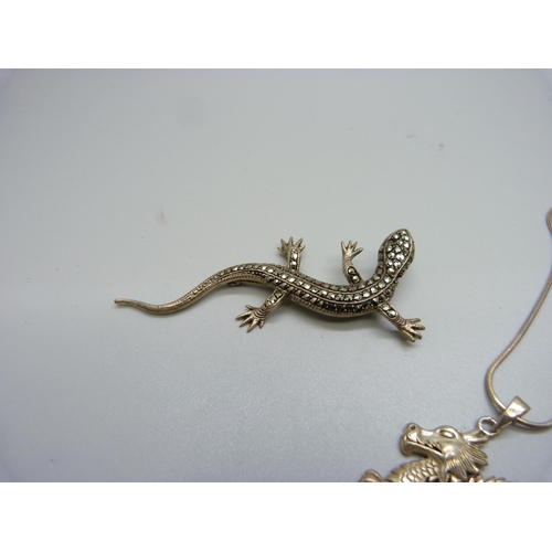 859 - A silver dragon pendant and chain and a silver and marcasite lizard brooch