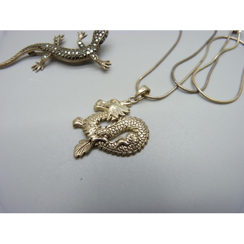 859 - A silver dragon pendant and chain and a silver and marcasite lizard brooch