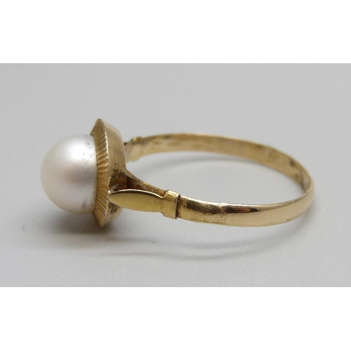 865 - A yellow metal and pearl ring, control marks on the outside of the shank, tests as 18ct gold, 1.5g, ... 