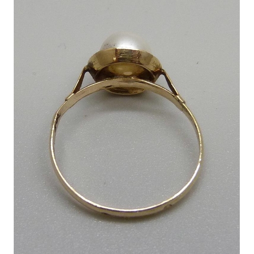 865 - A yellow metal and pearl ring, control marks on the outside of the shank, tests as 18ct gold, 1.5g, ... 