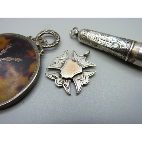 878 - A late Victorian silver mounted handbag mirror, a silver cheroot holder case and a silver fob