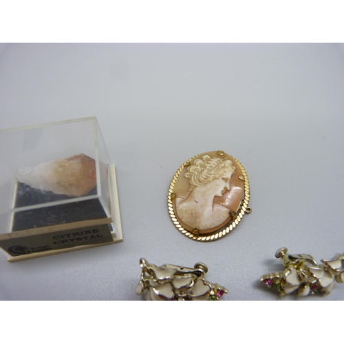 956 - A 9ct rolled gold cameo brooch, a costume necklace and earrings set and a citrine crystal