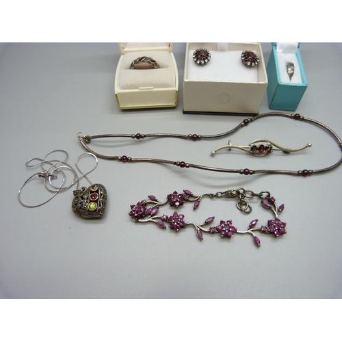 989 - A collection of silver stone set jewellery including a ruby set bracelet