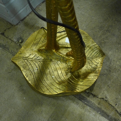 1406 - A gold floor standing flamingo lamp