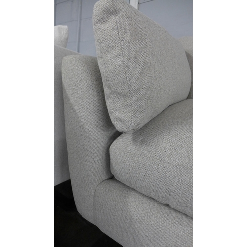 1442 - A light stone three seater sofa