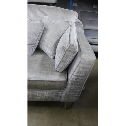 1447 - A stone velvet three seater sofa