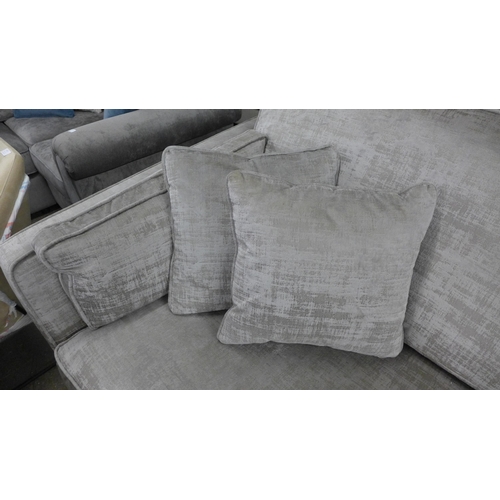 1447 - A stone velvet three seater sofa