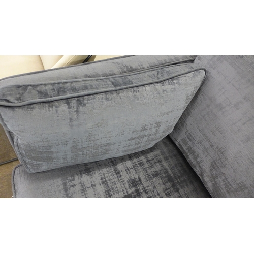 1448 - A charcoal velvet three seater sofa