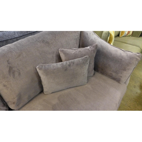 1450 - An aubergine velvet four seater sofa