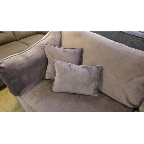 1450 - An aubergine velvet four seater sofa