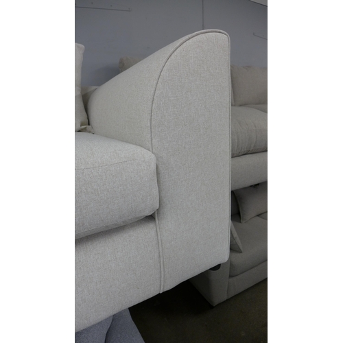 1482 - An oatmeal upholstered three seater sofa